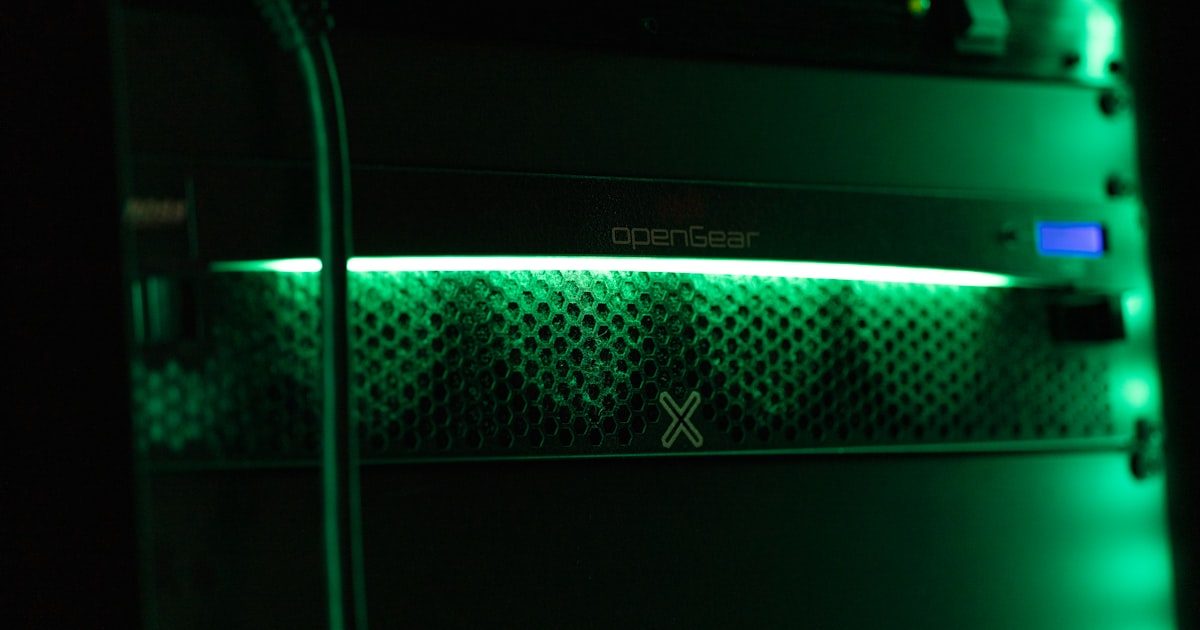 Server rack with blinking green status lights in a dark data center