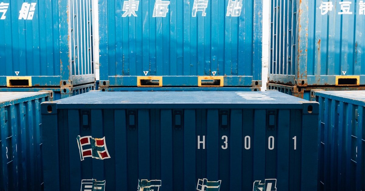 Aerial view of shipping containers representing global trade compliance